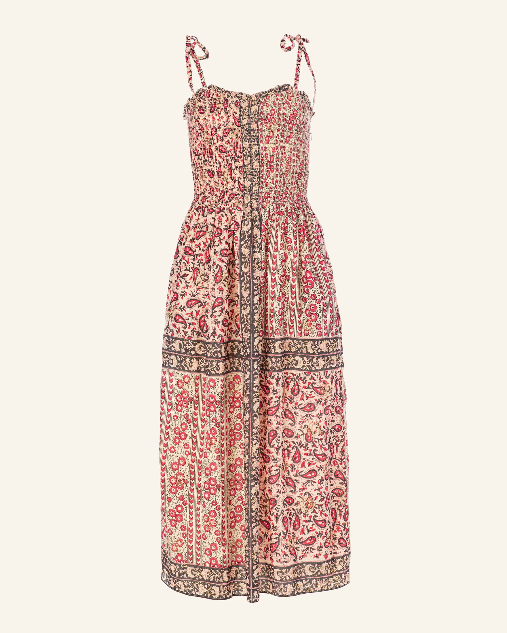 Introducing the Luna Bandana Dress: a sleeveless, long dress with a smocked sweetheart neckline and fitted bodice, adorned with tie shoulder straps. Made from hand-printed cotton, it showcases detailed floral patterns in red and beige tones accented by dark borders, achieving an elegant vintage-inspired look.