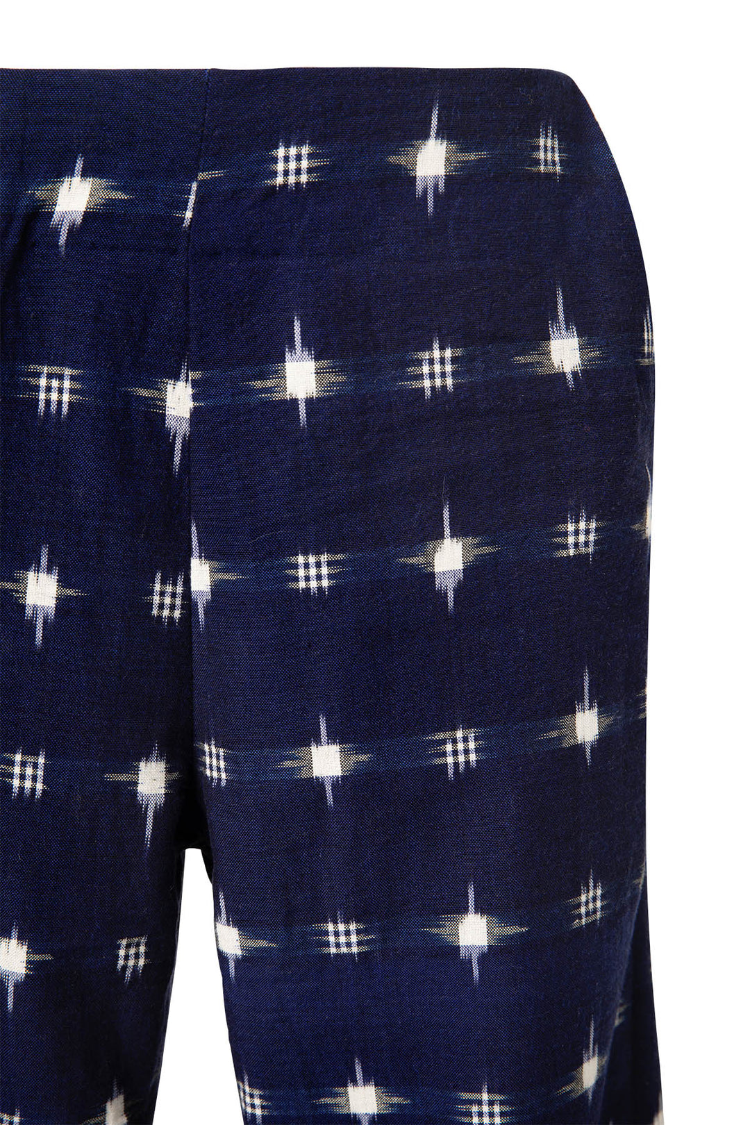 Close-up of the Charles Navy Ikat Spot Pant fabric, featuring a navy blue base adorned with a pattern of white geometric stars that evoke the traditional craftsmanship of Indian ikat.