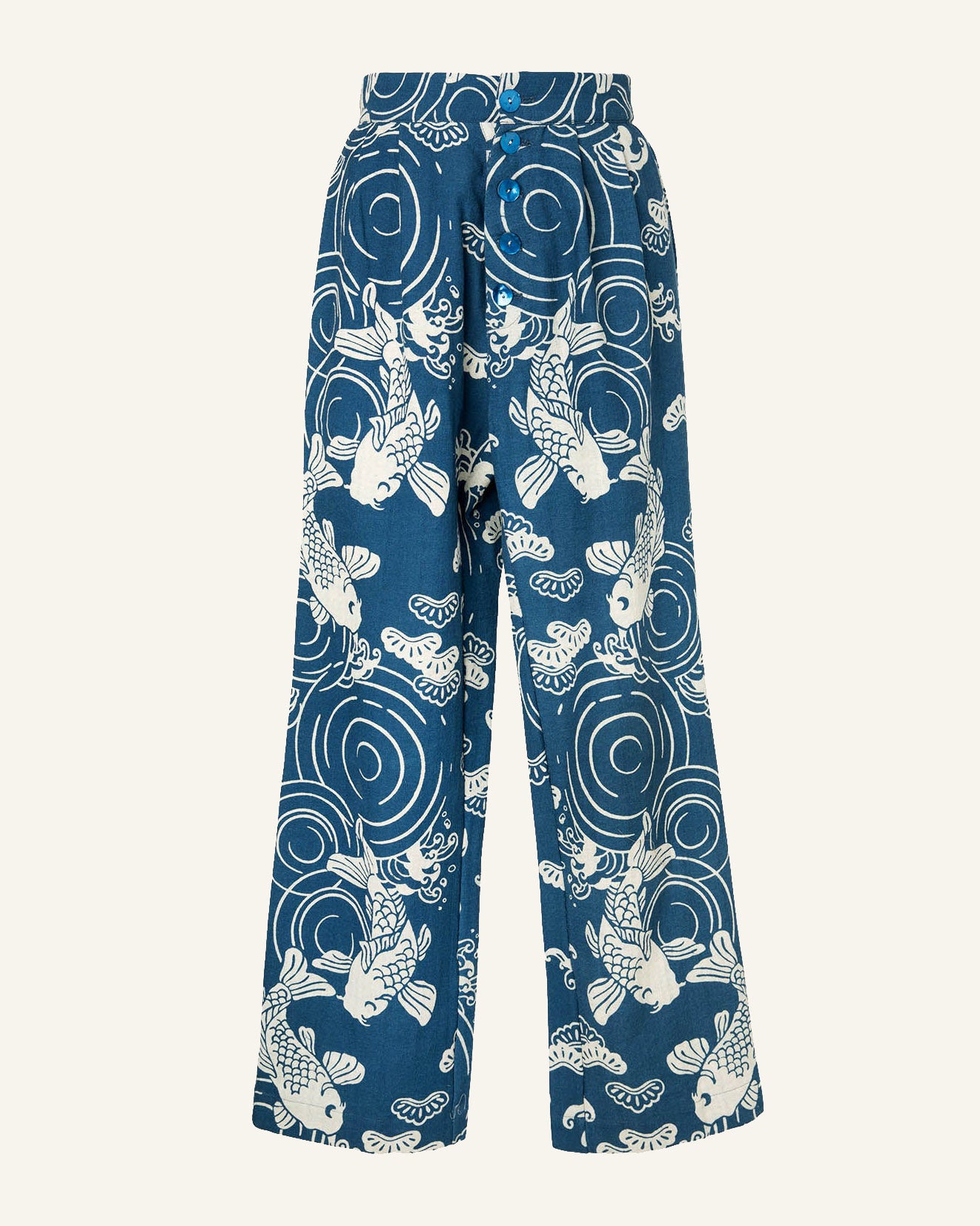 Catch Blue Fish Pant, featuring a wide-leg design with a white koi fish and water ripple pattern. This high-waisted piece includes button details and is set against a light, hand-printed background.