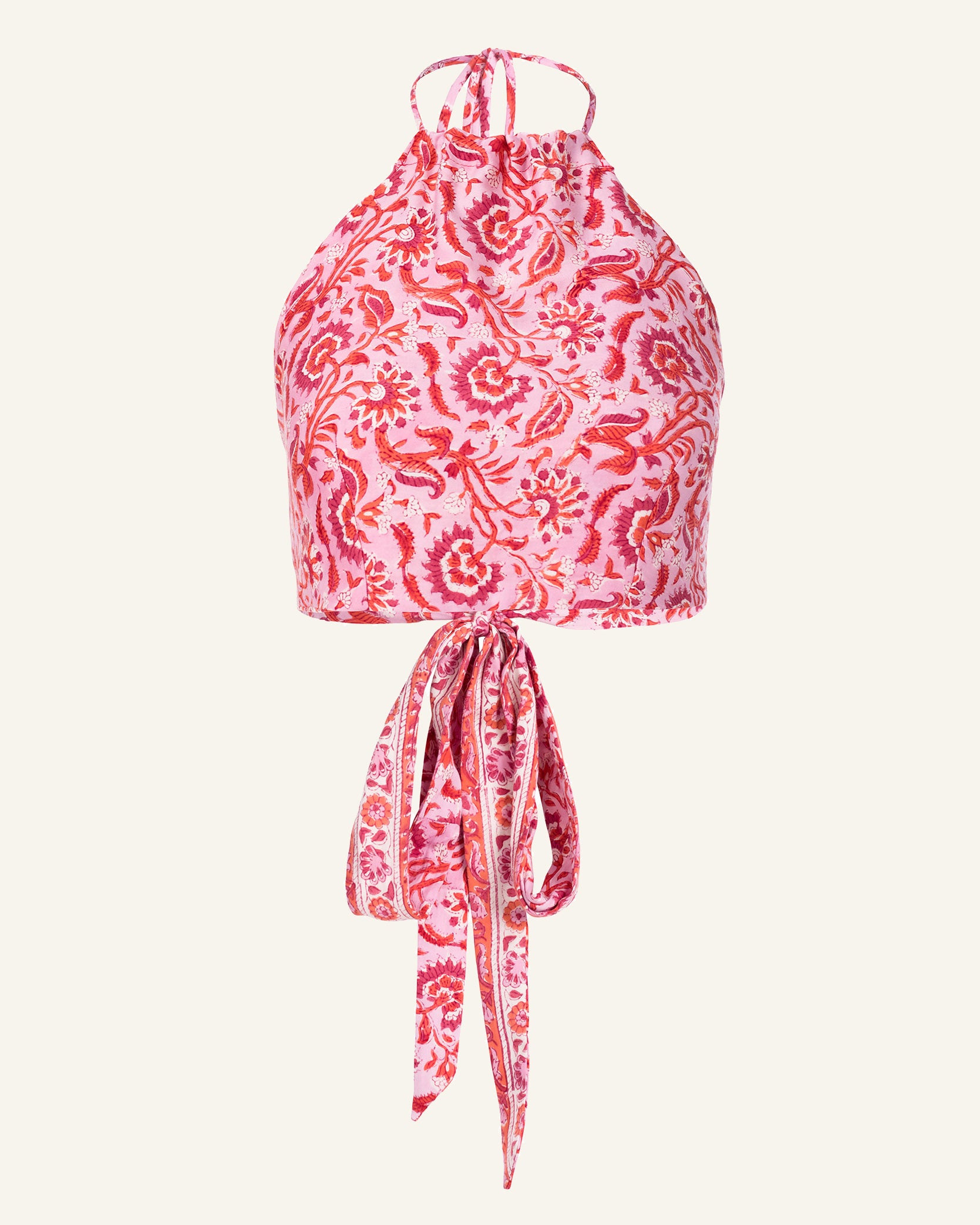 The Marmi Rosebloom Tie Top is a reversible halter top featuring a high neckline and tied back design, crafted from hand-printed cotton. The fabric displays an intricate red and white pattern of flowers and leaves, created using traditional methods.