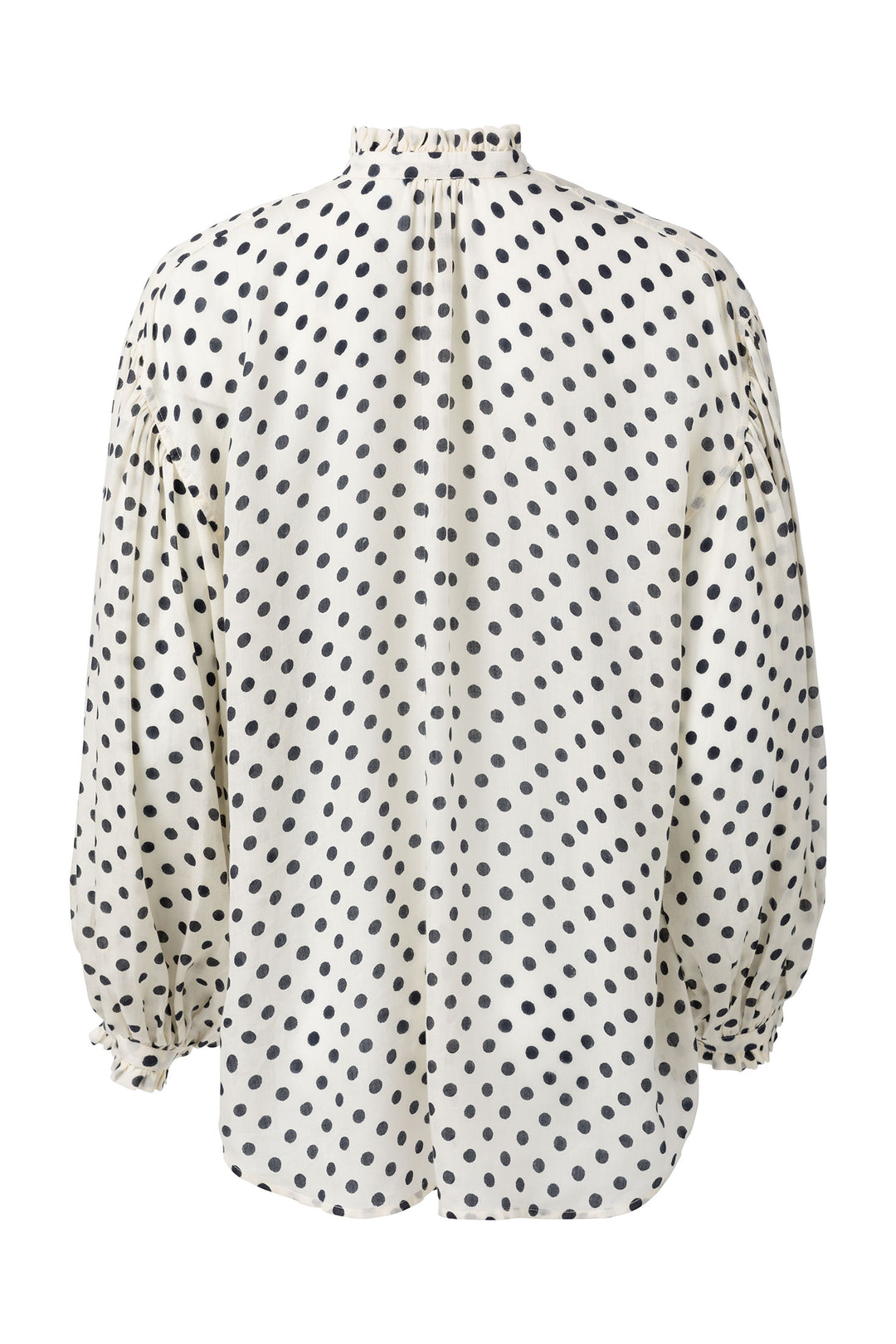 The Prima Tuxedo Spot Blouse is an elegantly hand-printed, white blouse adorned with black polka dots, crafted from a Cotton Tencel blend. It features a high, ruffled collar and long, puffed sleeves with gathered cuffs. The back view of this exquisite blouse is shown.