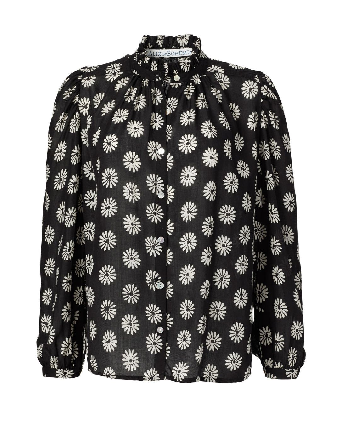 The Annabel Onyx Daisy Shirt is a black long-sleeve blouse adorned with a white daisy pattern, complete with a ruffled collar and puffed sleeves.