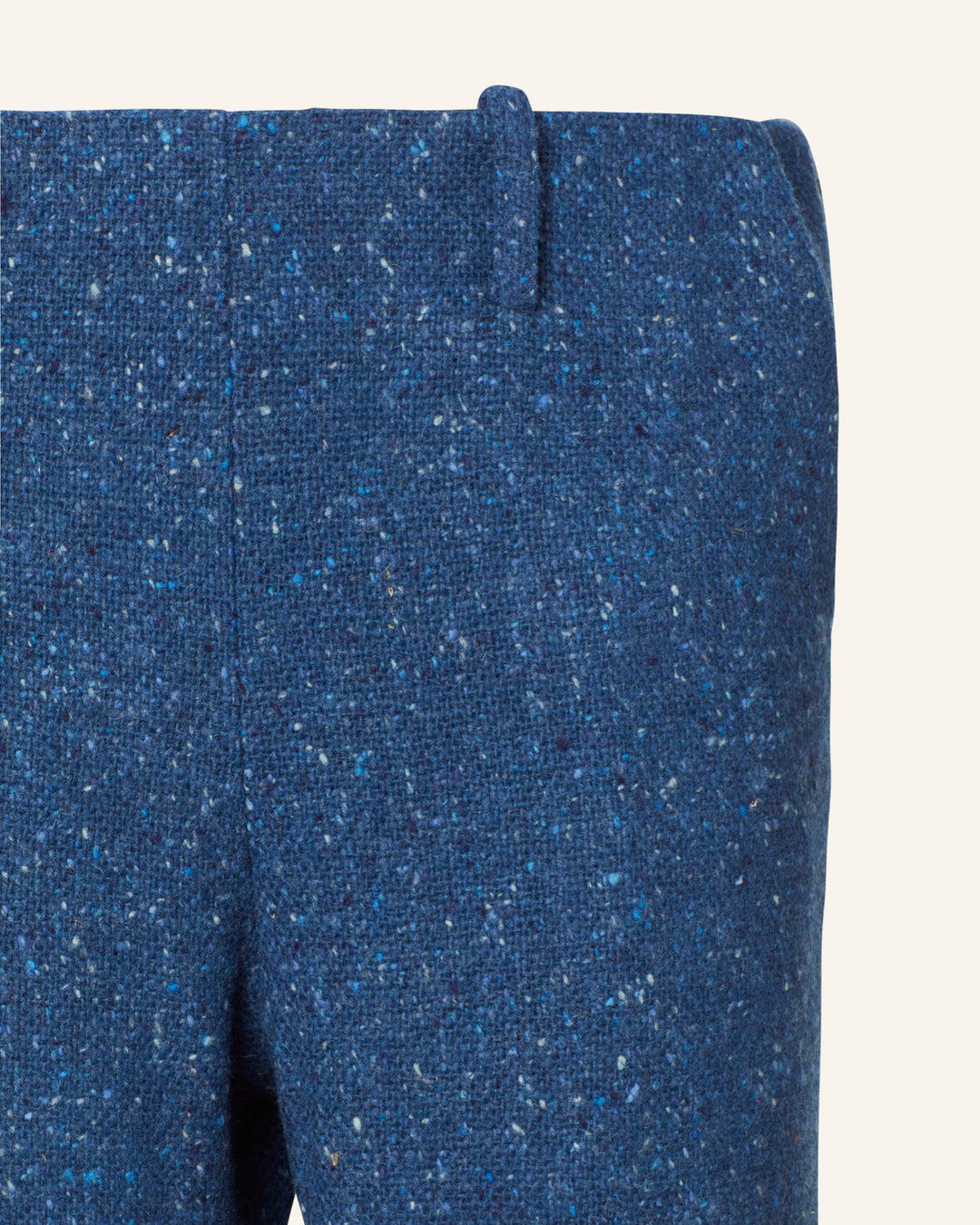 Close-up of the Charlie Blueberry Tweed Pant, crafted in English wool with a textured pattern and subtle speckles, featuring belt loops, a visible seam, and a side zipper.