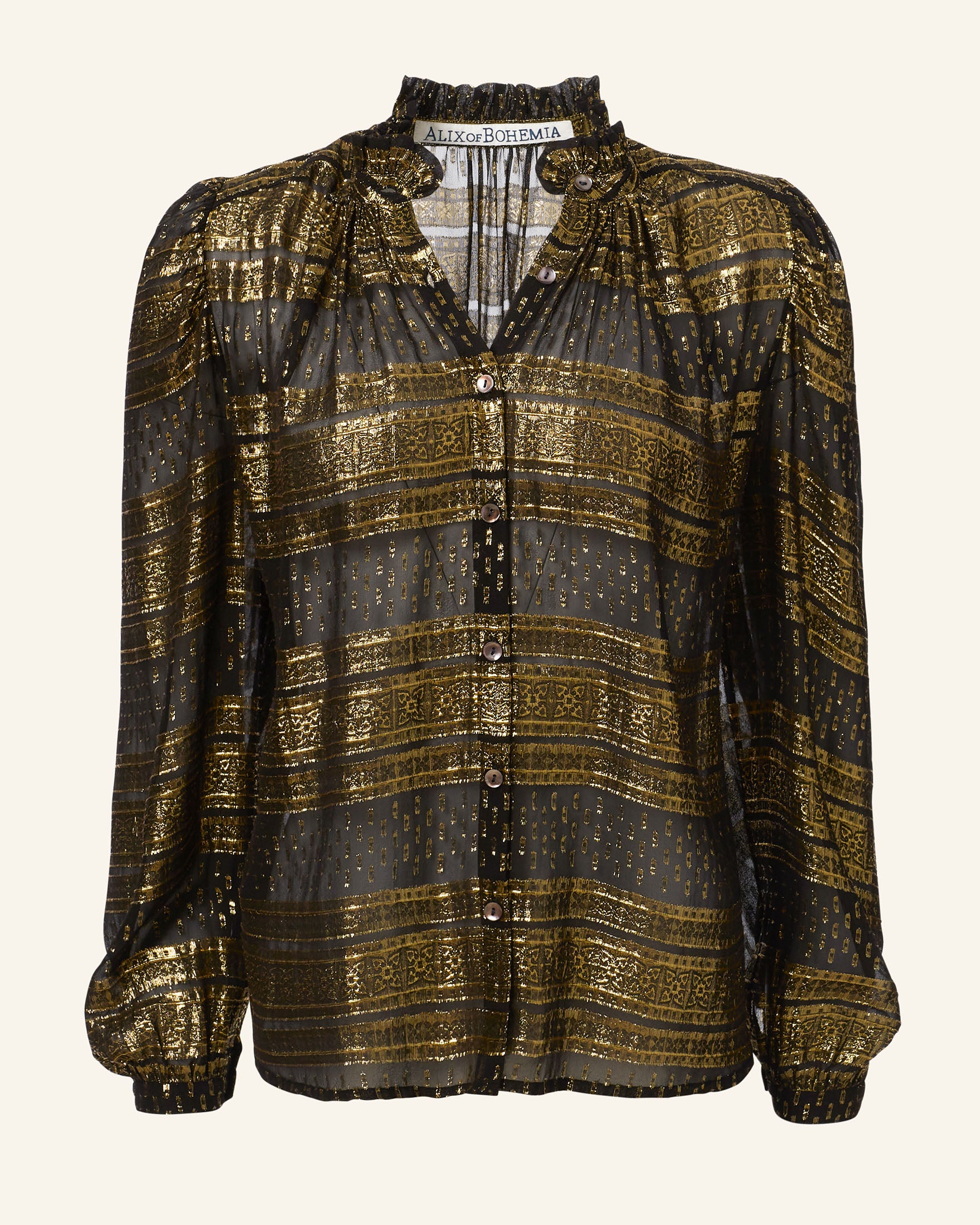 The Annabel Gilded Lily Shirt is a vintage-inspired sheer black blouse made from fil-coupé silk chiffon, adorned with golden vertical and horizontal stripes. It boasts a high ruffled collar, long puffed sleeves, and front buttons, all highlighted by a delicate shimmering pattern for an elegant finish.