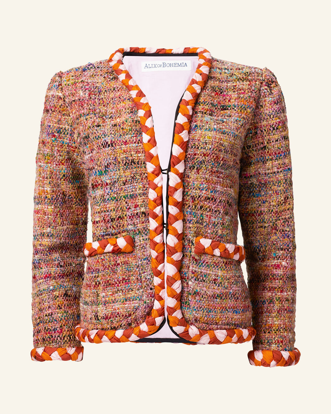 The Billie Rose Dust Bouclé Jacket showcases multicolored fabric with orange and white hand-braided silk trim along the edges and pockets, set against a plain backdrop.