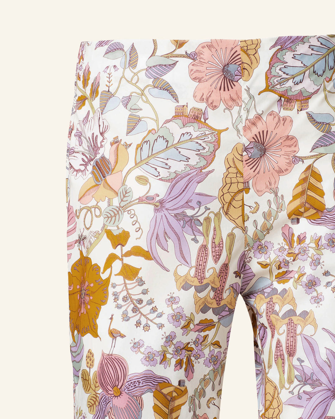 Close-up of the Farah Faded Eden Flare Pant, featuring a vibrant Liberty-print floral and leaf pattern. The vintage-inspired '70s design displays large flowers and leaves in shades of pink, purple, yellow, and orange on a light Italian cotton background.