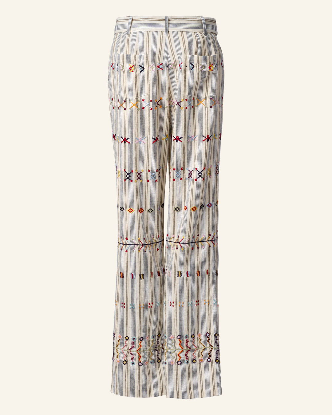 Side view of light-colored striped Colette Arrow Linen Pants in Khadi cotton, adorned with colorful hand-embroidered geometric shapes and lines that add a vibrant touch to the fabric. These high-waisted pants feature a straight-leg design and belt loops.