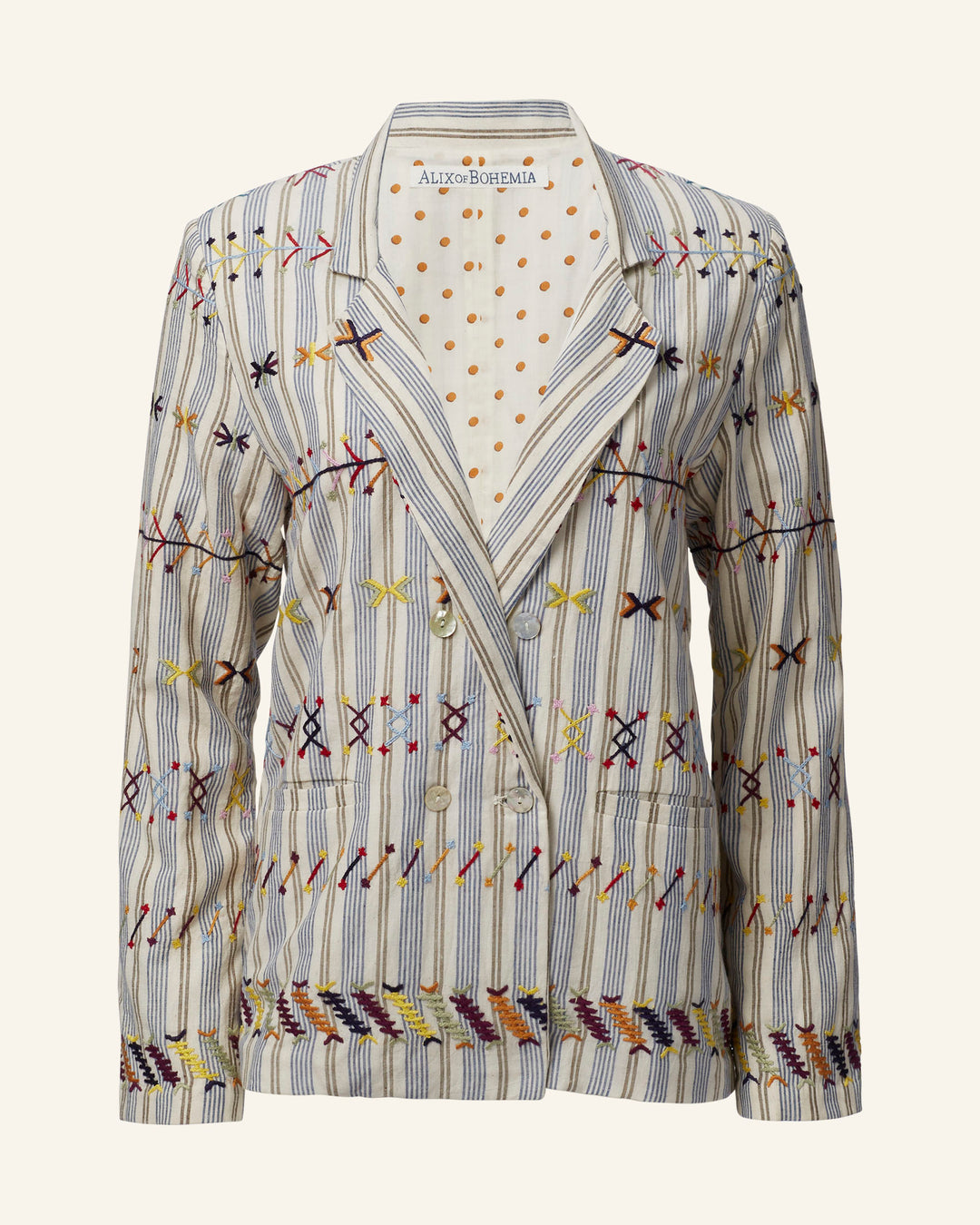 Introducing the "Elodie Arrow Linen Jacket," a hand-embroidered double-breasted piece that showcases colorful geometric patterns on striped Khadi cotton. This jacket is adorned with mother-of-pearl buttons and features a cream lining highlighted with gold polka dots. The "Alexa Bohemia" label inside the collar enhances its sophisticated appeal.