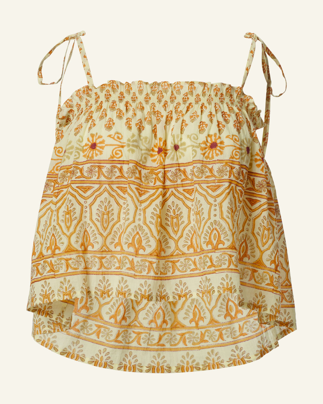 The Lila Saffron Bhutti Top is crafted from airy cotton voile, showcasing yellow and orange block-printed patterns in a bohemian floral motif. It features a ruffled design with thin straps tied into small bows, displaying intricate floral and geometric motifs.