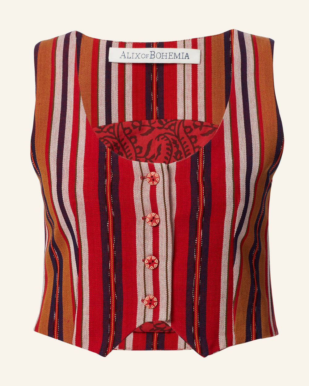 Introducing the Mossie Canyon Stripe Top: A cropped vest adorned with vertical stripes in shades of red, orange, brown, and navy. This piece showcases floral-patterned, cloth-covered buttons and features an inner chest pocket for added bohemian flair. Proudly labeled "Alix of Bohemia.