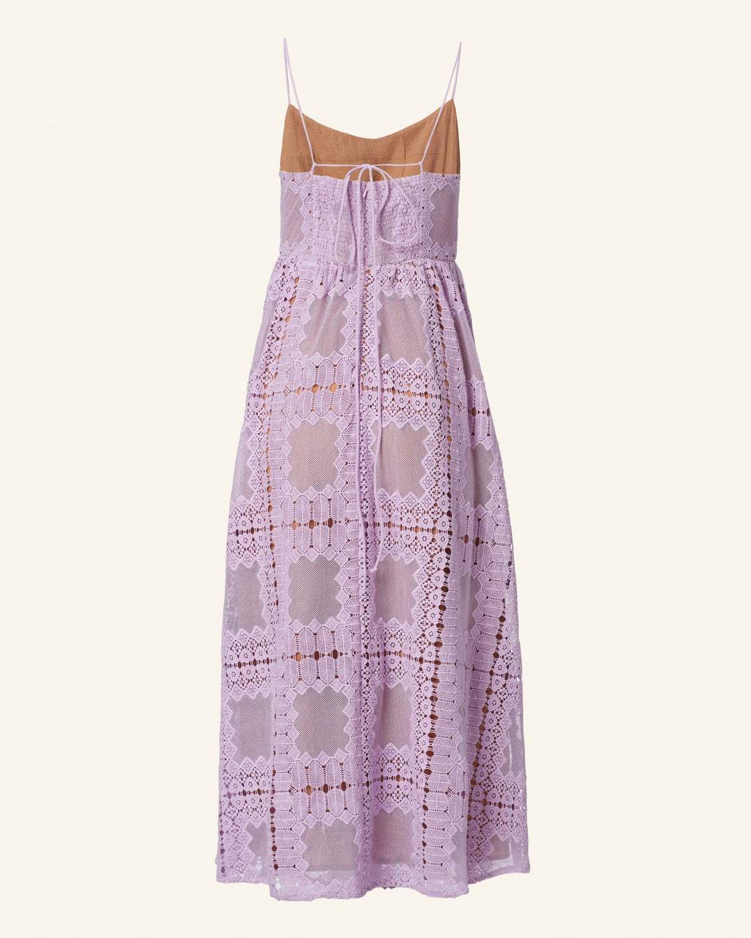 Introducing the Autumn Lavender Picnic Dress, a light lavender midi dress styled with delicate spaghetti straps and a detailed geometric lace pattern over a nude underlay. Ideal for wedding guest attire, this dress boasts a fitted bodice with a charming front tie and a graceful flowy mid-length skirt.