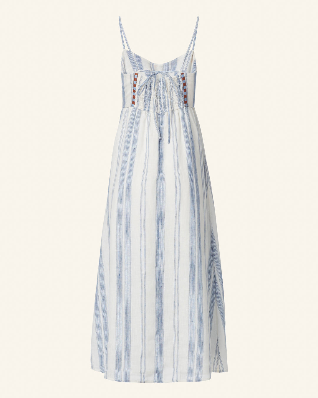 Introducing the Autumn Pacific Delta Dress: a sleeveless, cotton masterpiece featuring a floor-length design. Adorned with thin straps and elegant vertical blue stripes on a pristine white background, this dress showcases a charming lace-up front detail and offers a flowing silhouette that makes it an ideal choice for summer occasions.