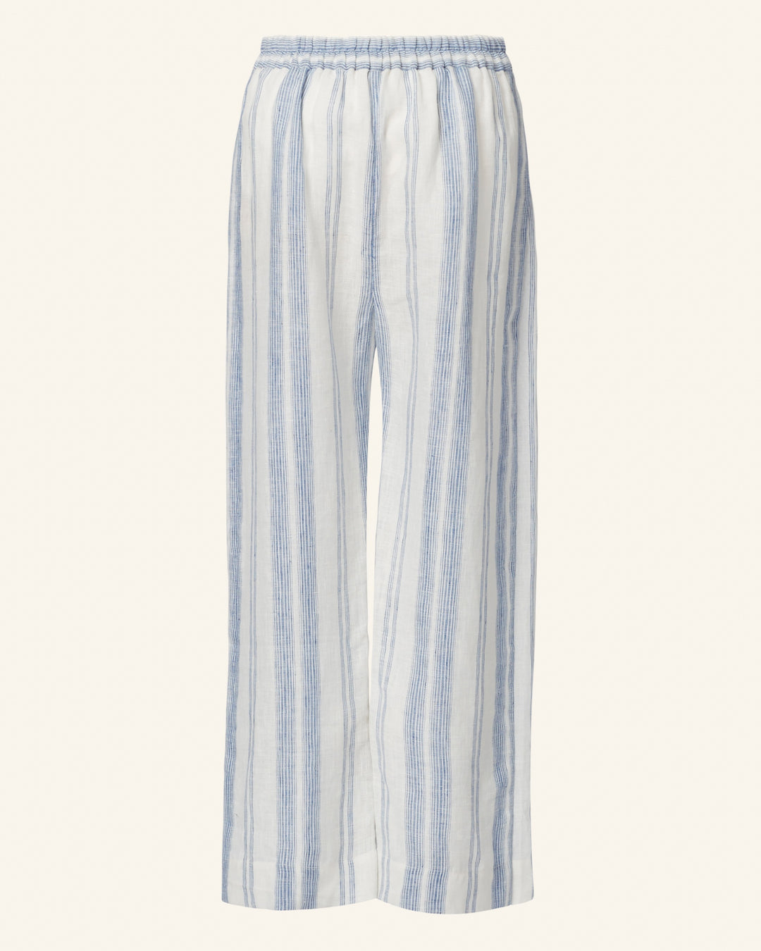 The Bonnie Pacific Wrap Pant is a pair of loose-fitting, lightweight pants with vertical blue and white stripes, featuring an elastic waistband reminiscent of a vintage-inspired dress.