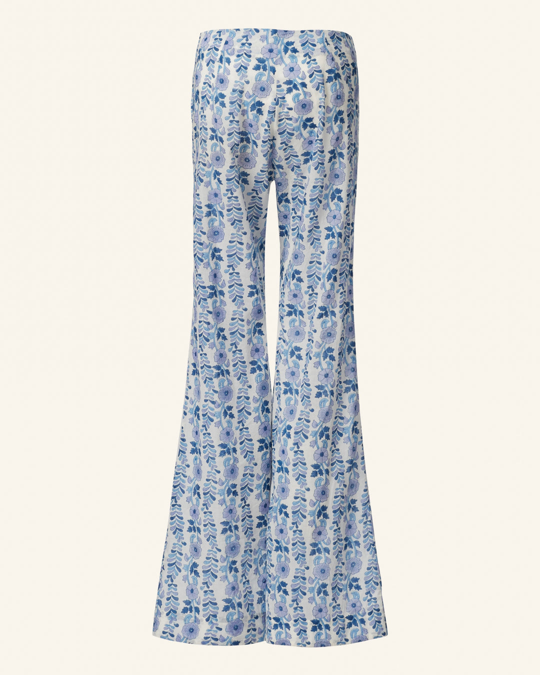 The Charlie Iris Ivy Pant is a pair of high-waisted, wide-leg pants showcasing a hand-block printed blue and white floral pattern on a light background.