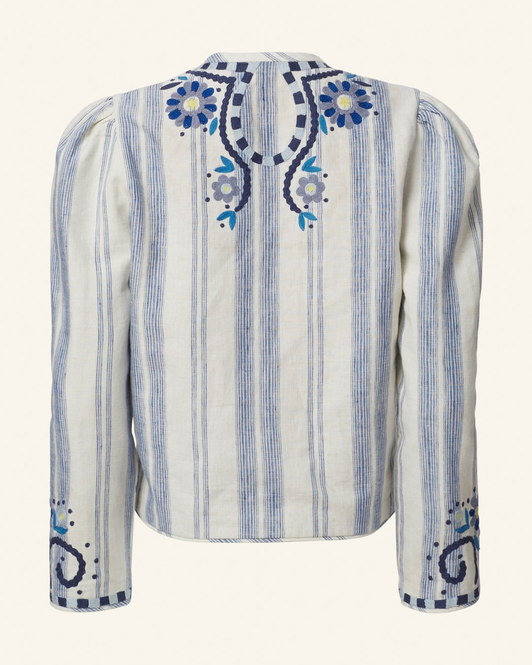 The Fiorello Pacific Reef Jacket is a long-sleeved, cream blazer crafted from a silk-linen blend, adorned with vertical blue stripes and intricate floral embroidery in shades of blue and purple on the back and sleeves. It boasts hand-embellished details, puffed shoulders, a traditional design, and a subtly printed floral lining.