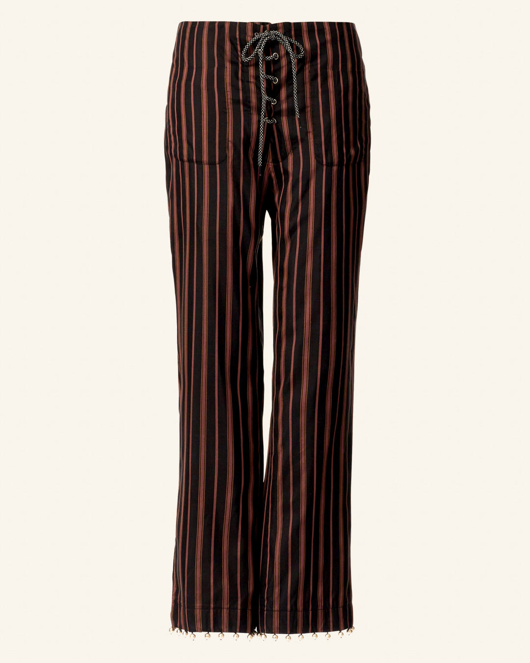 Jodphur Clove Beaded Pant featuring vertical black and brown stripes, a lace-up front, hand-block printed linen, and fringe detailing at the hems.