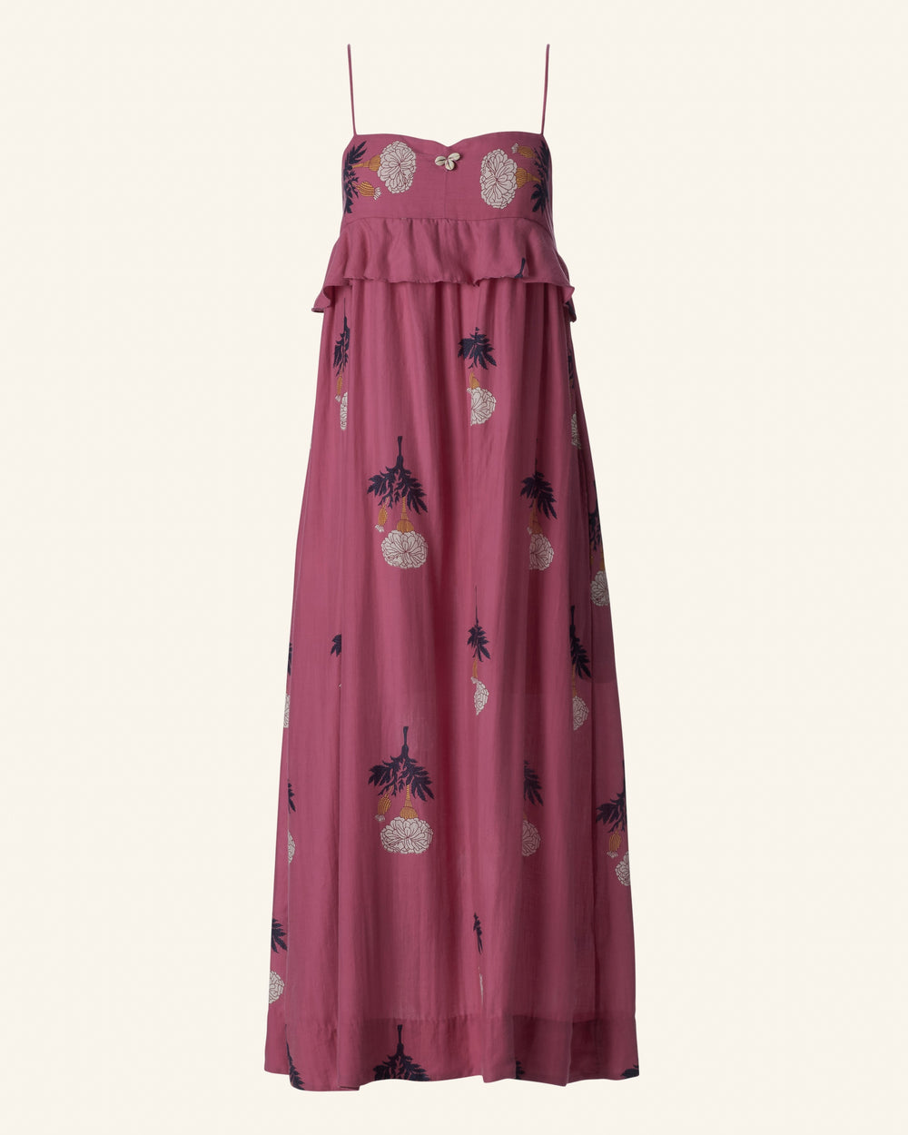 The Martina Hibiscus Rose Dress is a sleeveless maxi dress featuring a pink floral print with pineapple embroidery and thin straps, made from breezy Tencel—ideal for summer wear.