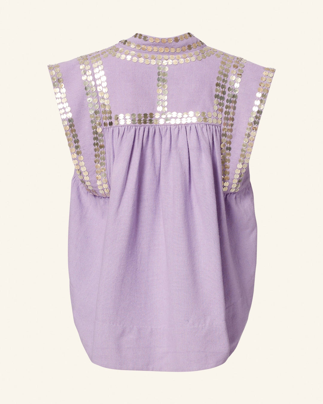 The Nehru Lavender Coin Top is a sleeveless blouse crafted from Banaras silk, adorned with gold sequin embellishments on the shoulders and upper back. It features a loose fit and gathered detailing at the back, exuding elegance in every stitch.