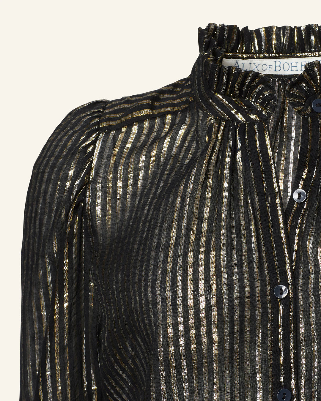 The Artemis Moonlight Shirt captures '70s disco flair with its black design featuring metallic gold vertical stripes and a ruffled collar. Complete with black buttons down the front, this sheer and lightweight fabric adds a touch of shimmering sophistication to any outfit.