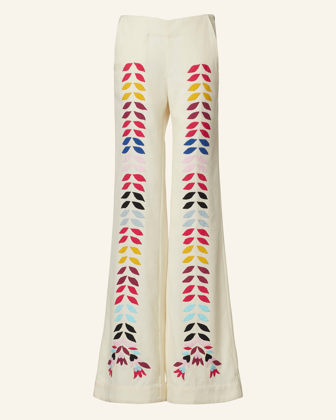 The Charlie Ivory Prism Pant features a wide-leg design with colorful geometric patterns, reflecting a '70s-style flair. It showcases red, pink, yellow, and black shapes that run down the front.