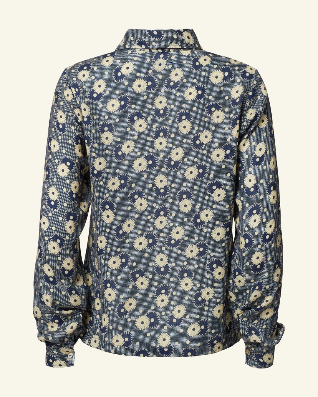 Back view of the Dolly Navy Daisy Shirt, featuring a vintage-inspired design with a blue and white retro floral pattern and long sleeves.