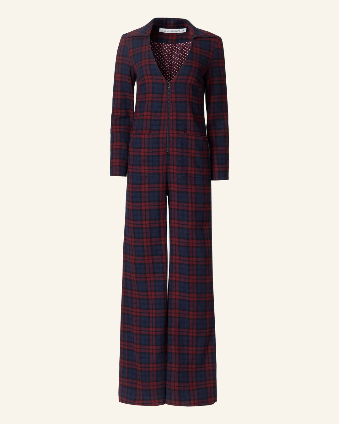 Introducing the Louisa Berry Plaid Jumpsuit: a stylish long-sleeved jumpsuit in dark blue and red tartan, featuring a deep V-neck and wide-legged pants on a plain background, with a luxurious cotton-silk lining.