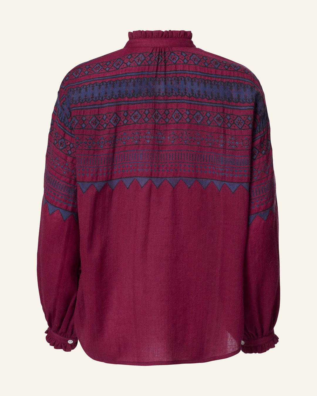 Back view of the Poet Plum Fairisle Blouse, featuring a maroon design with blue geometric patterns and adorned with ruffled cuffs and collar, exuding a vintage-inspired style.