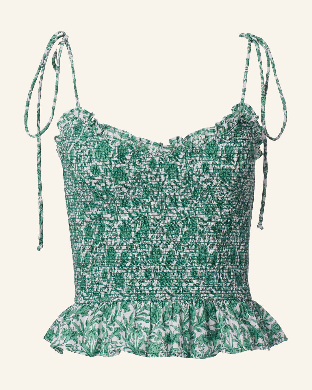 The Clara Laurel Vine Top is a sleeveless, Liberty-print green and white floral top with adjustable tie-up shoulder straps and a ruffled hem.