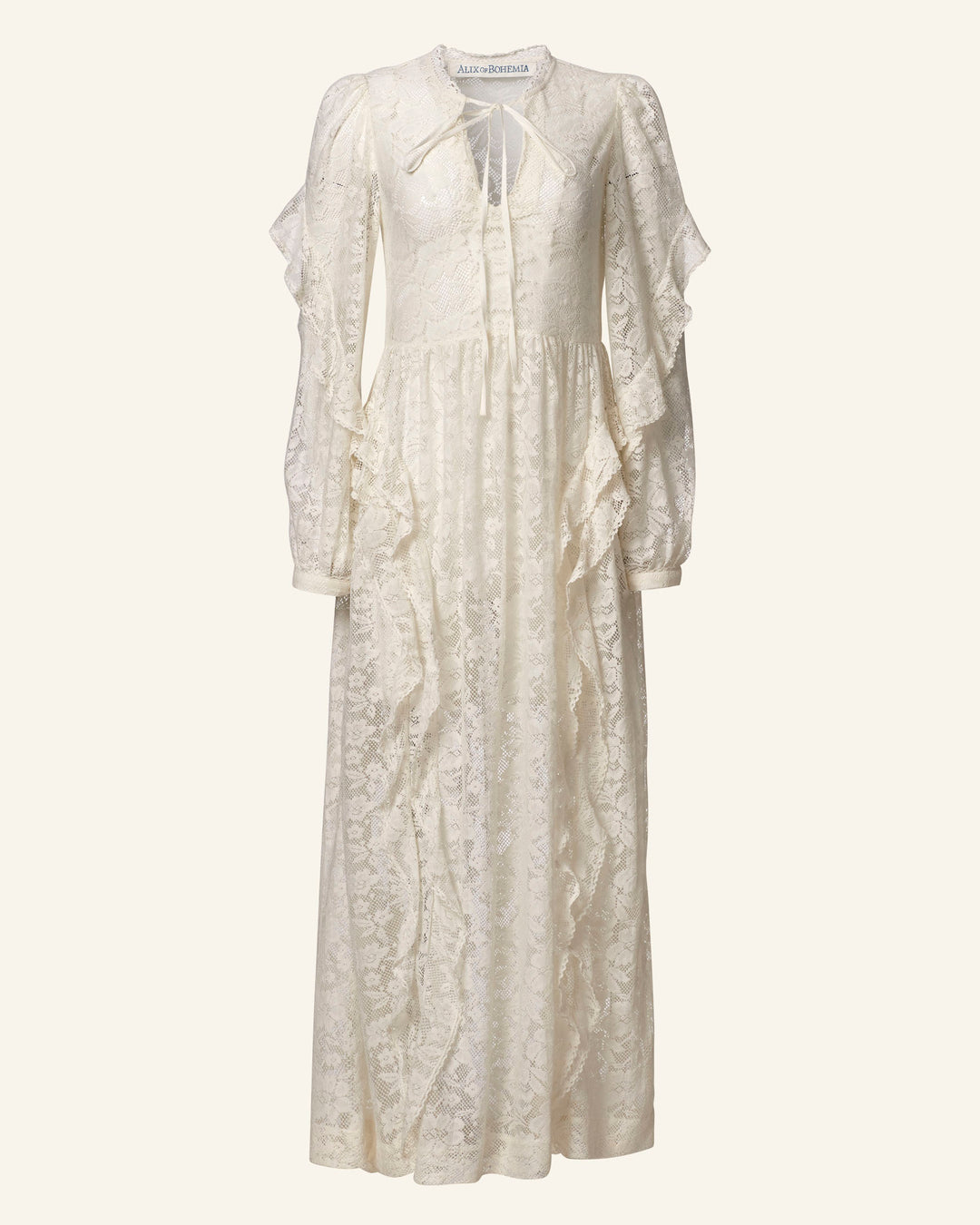 The Lina Magnolia Lace Dress is an ivory maxi with long sleeves, featuring elegant floral lace, ruffled details, a high neck, and a charming keyhole. Button closures highlight its graceful, floor-length silhouette.