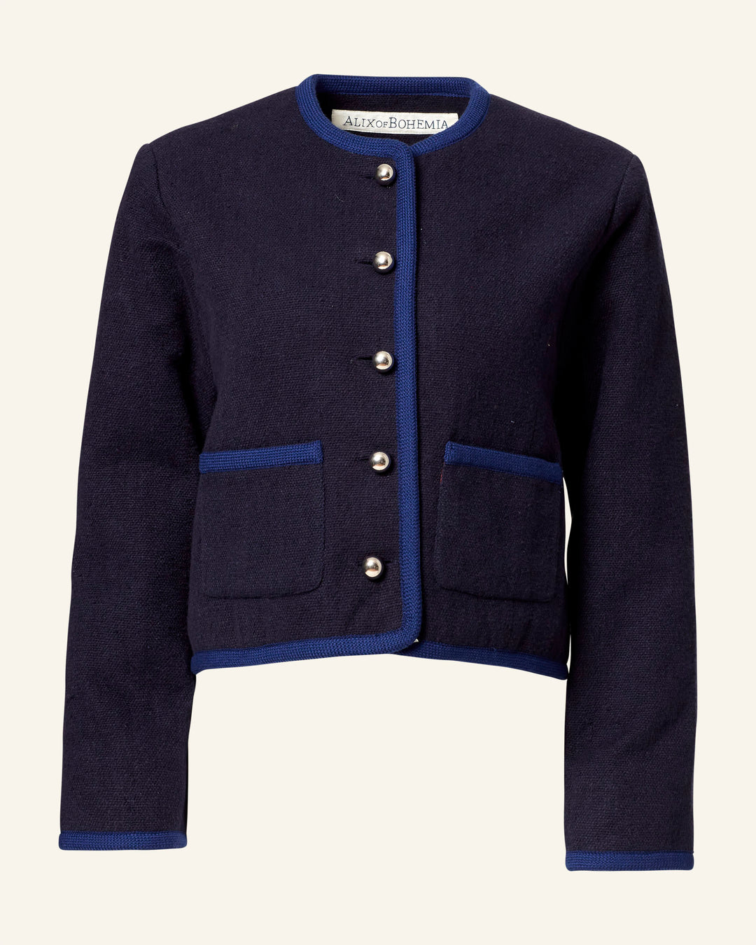 The Rowan Midnight Swallow Jacket, made from Khadi cotton in navy blue, has a round neckline and blue trim along the edges. It features silver buttons down the front and two pockets. The label inside says "Alex of Bohemia," highlighting its artisan craftsmanship.