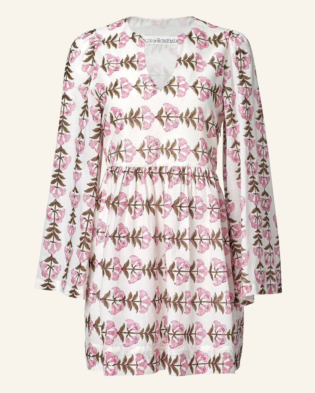 The Silvie Trumpet Lily Dress features a V-neck and long sleeves, crafted from airy cotton voile with pink flowers and green leaves on a white background for a fresh, breezy feel.