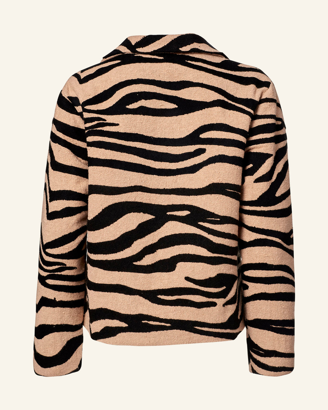 An animal print jacket with wild flair, the Western Zebra Mirage Jacket features long sleeves and black zebra stripes over a light beige background. Crafted from textured Khadi cotton, it boasts a stylish collar that makes its unique pattern pop against any plain backdrop.