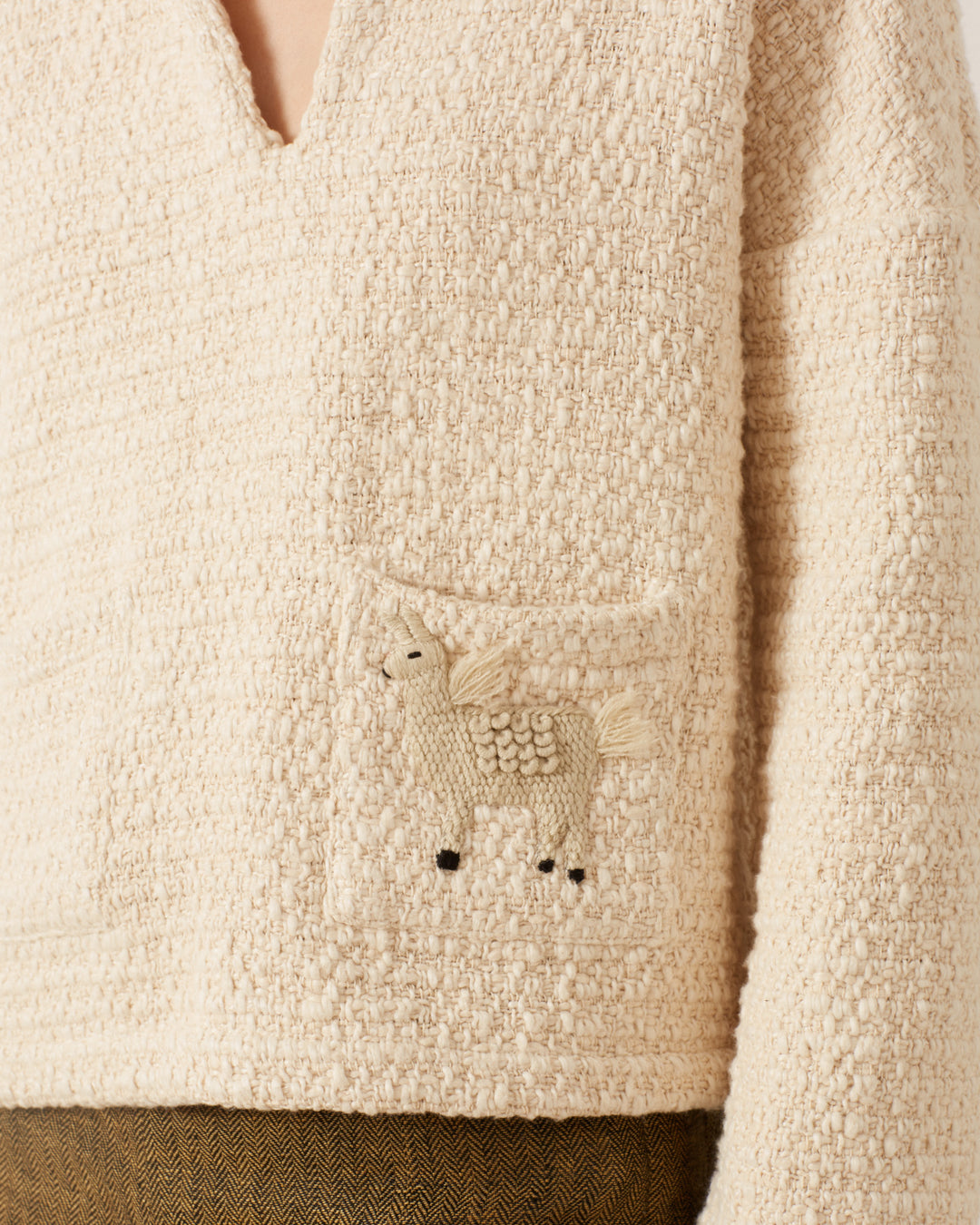 Allegra Pearl Boucle Top featuring a small, hand-embroidered unicorn on the pocket.