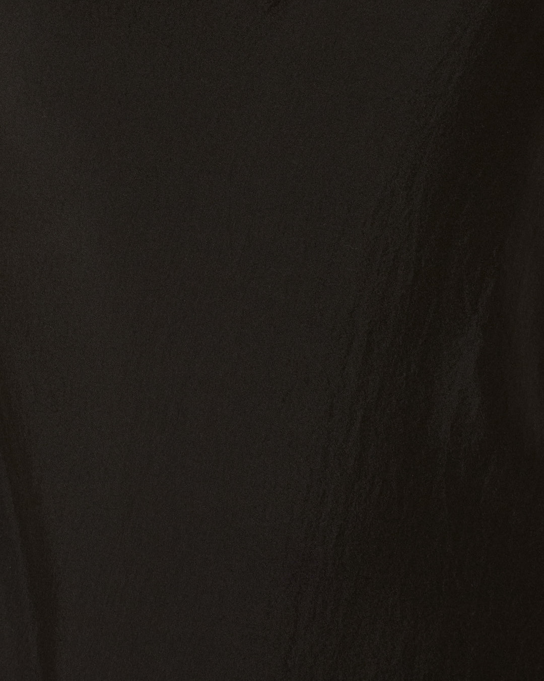 Adele Noir Silk Dress: Textured black surface with subtle light reflections and fine creases, evoking the elegance of hand-loomed silk.