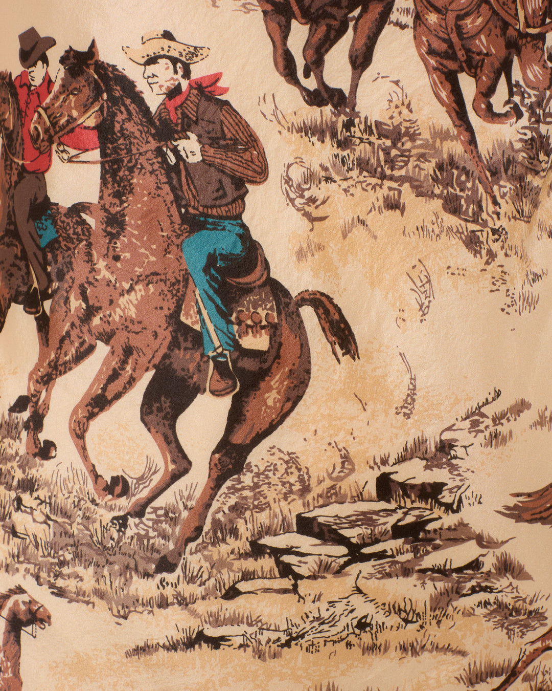 Illustration of two cowboys riding through grassy, rocky terrain, one wearing the Adele Canyon Cowboy Silk Dress, with other riders partially visible in the background.