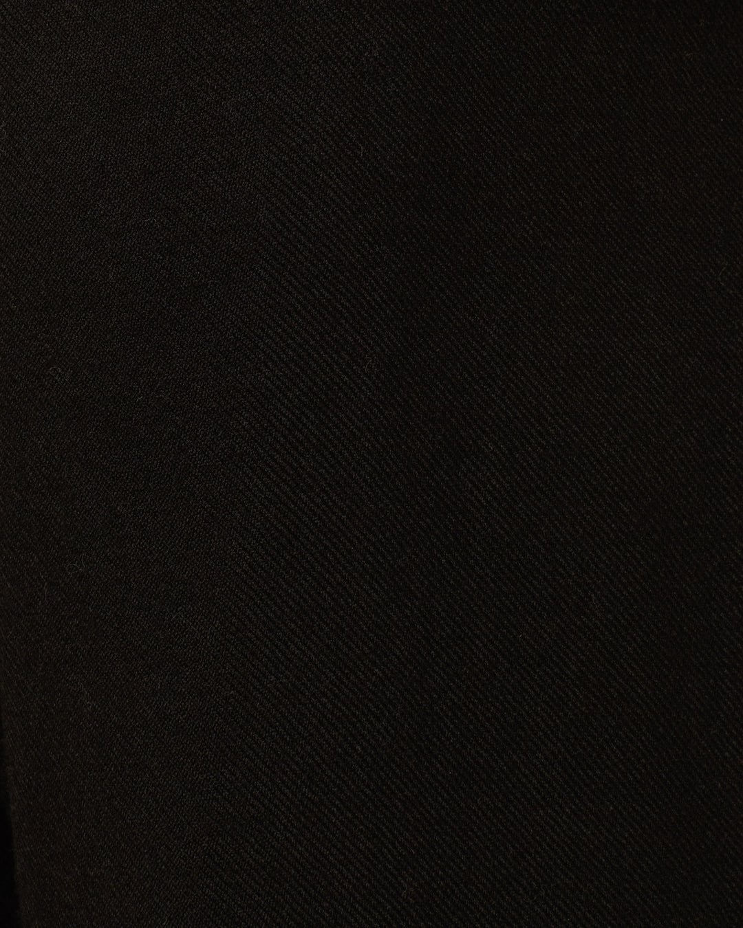 Close-up view of the Jude Raven Fringe Jacket's black fabric, featuring a subtle diagonal weave pattern that highlights the fine detail characteristic of artisan garments.