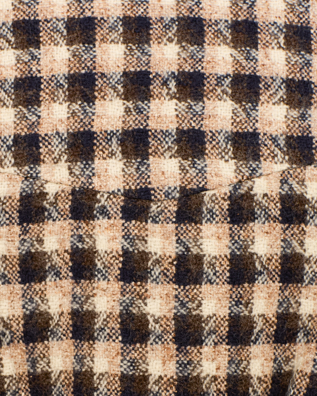 Close-up of the Eli Trail Dust Bomber Jacket’s plaid fabric in brown, black, and beige wool with a curved center seam—classic Italian style.