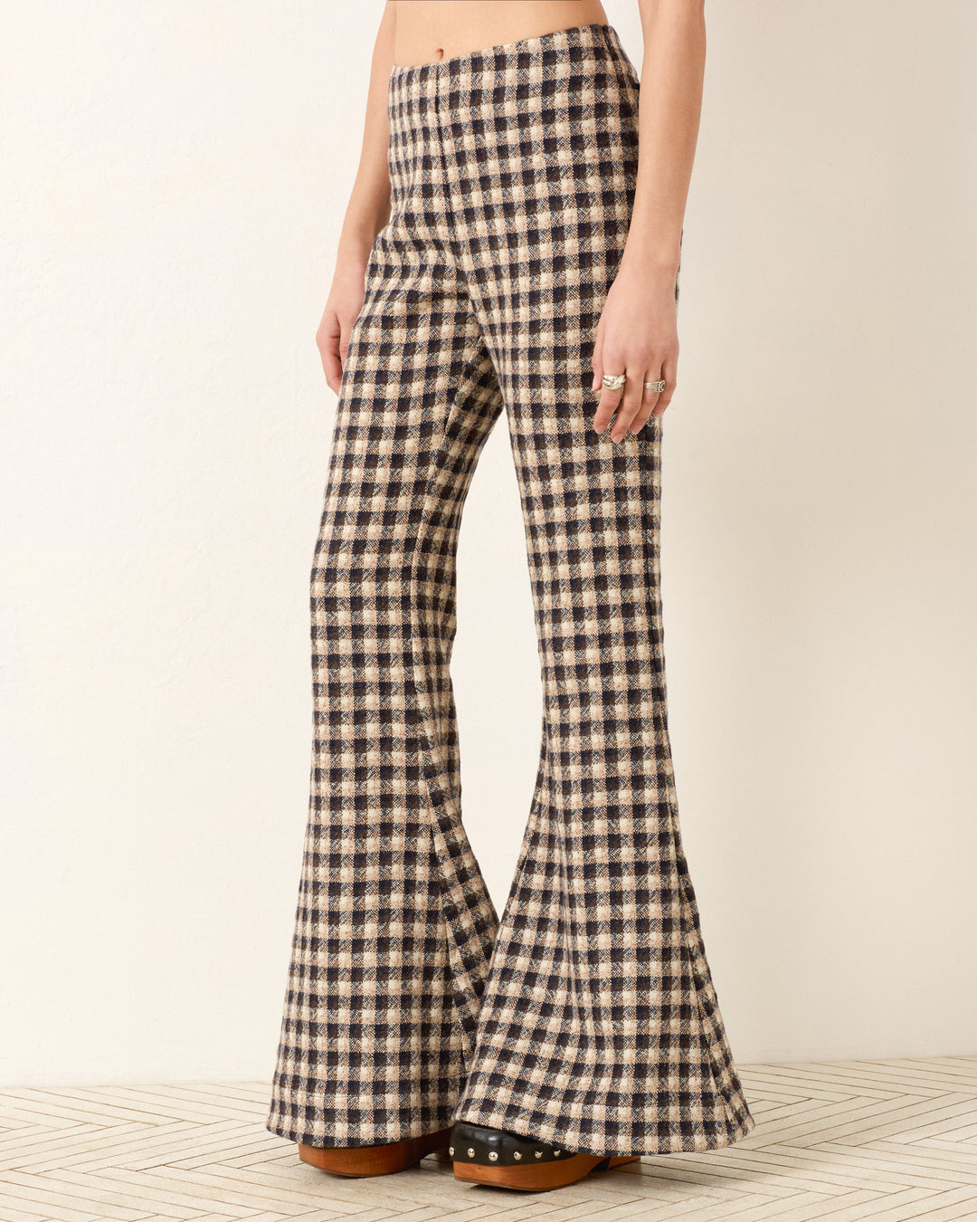 A person wearing the Farah Trail Dust Pant with high waist and bell-bottom flare, paired with brown platform shoes, stands against a plain background.