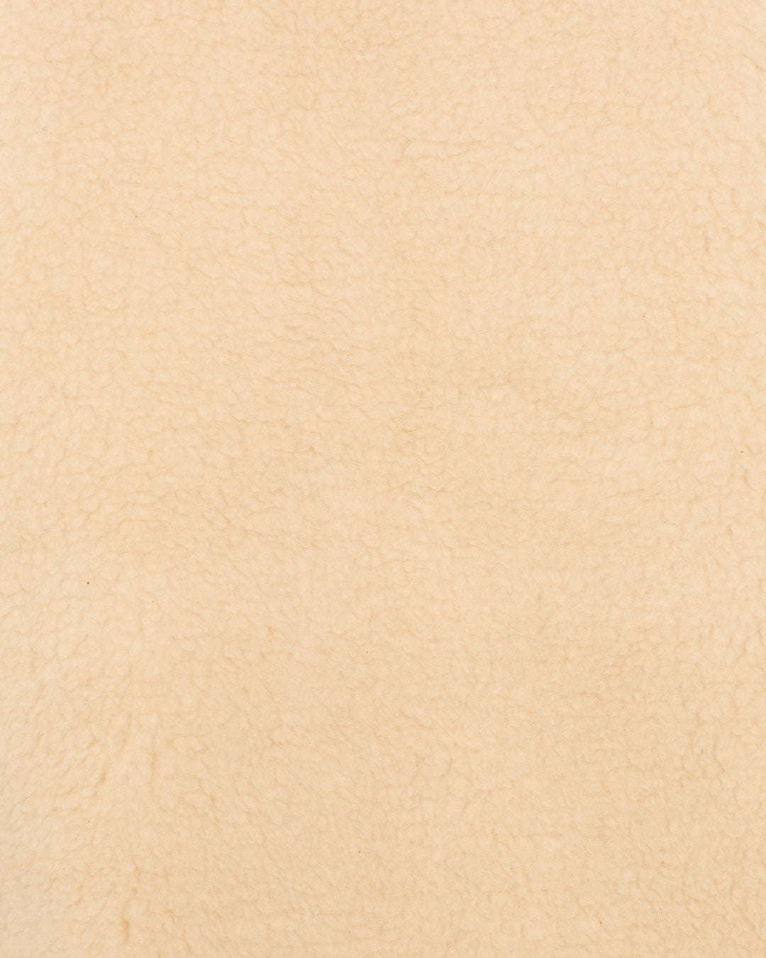 Close-up of the soft, textured beige fabric of the Harrow Cactus Spur Vest, resembling fleece or wool—ideal for Western-inspired style.