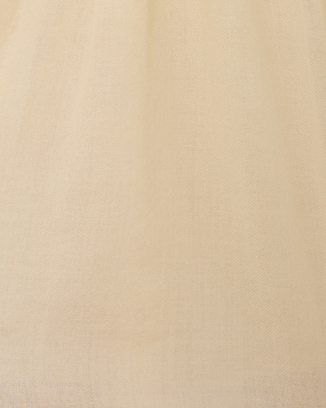 Close-up of the Jolie Snow Beam Dress’s plain, light beige woven fabric, featuring a subtle texture and fine threads—perfect for hand embroidery or an understated band collar accent.