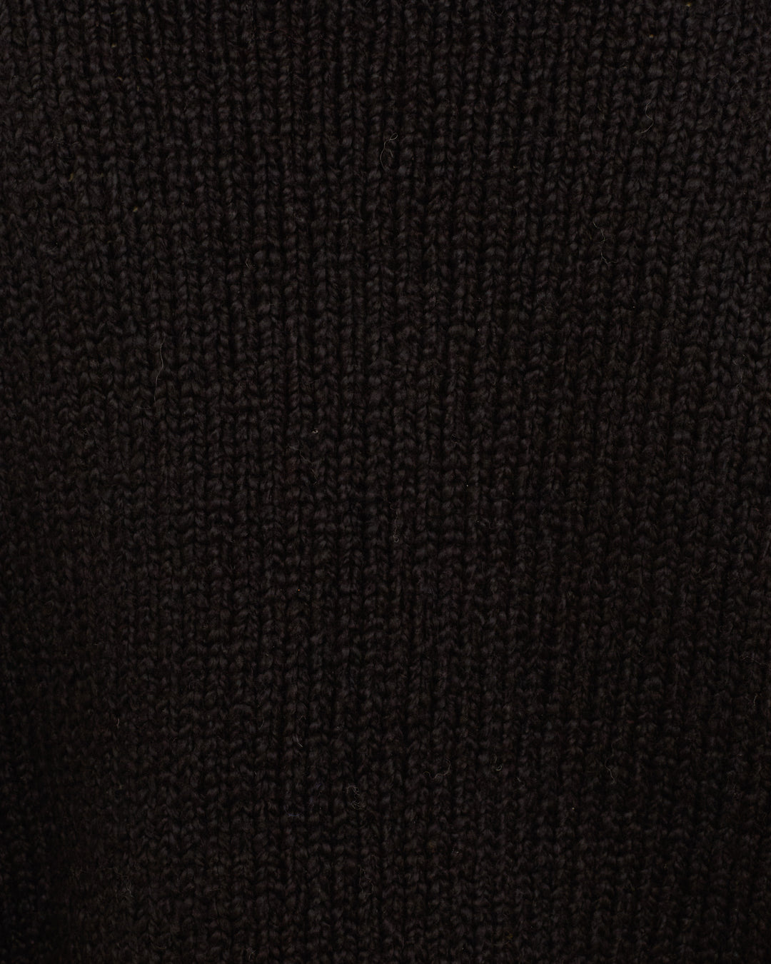 Close-up of the ribbed, dark brown knit texture from the Leigh Cow Skull Sweater, made with organic cotton.