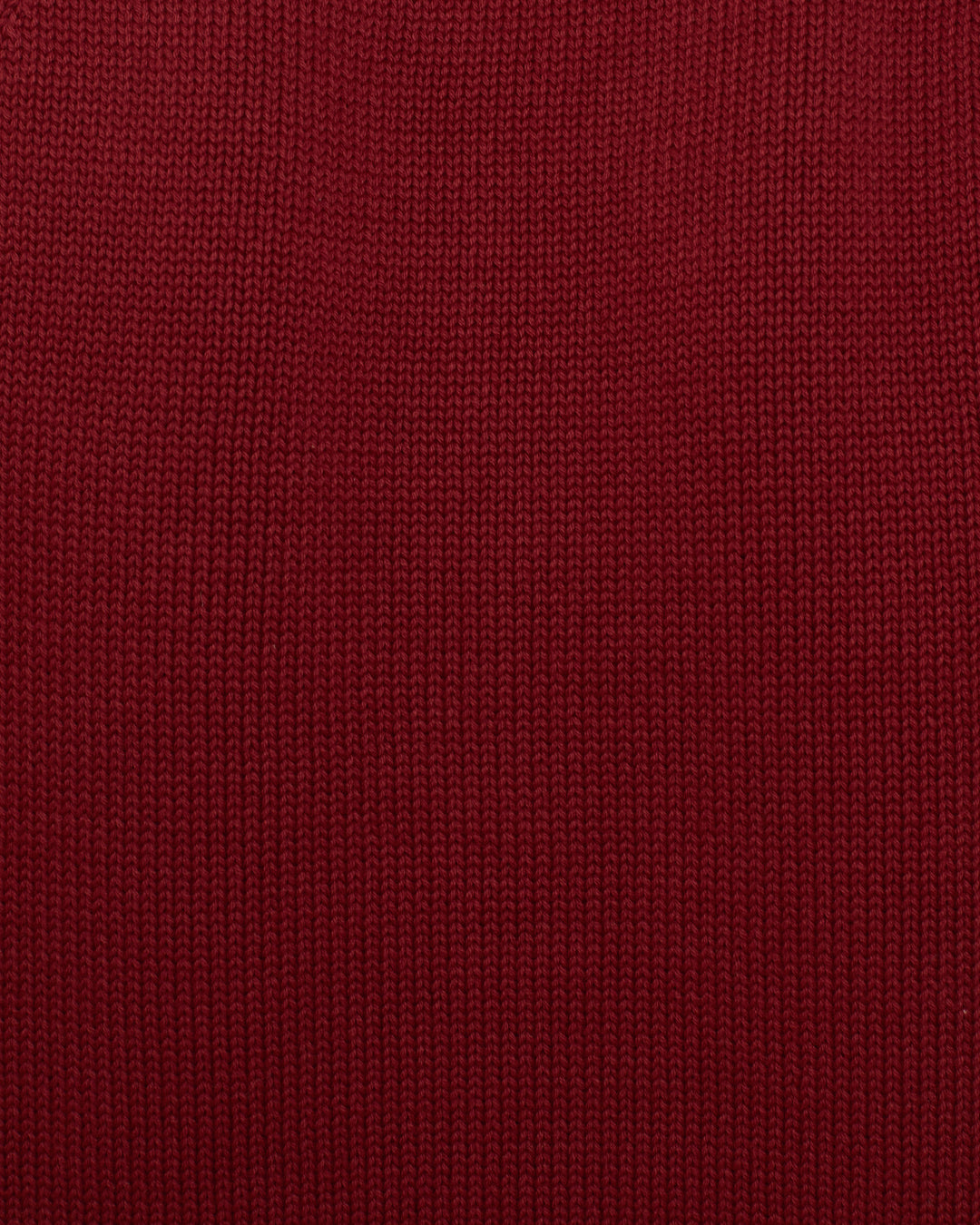 Close-up view of the Lessi Mesa Knit Top, a red cropped cotton sweater featuring a vertical ribbed pattern.