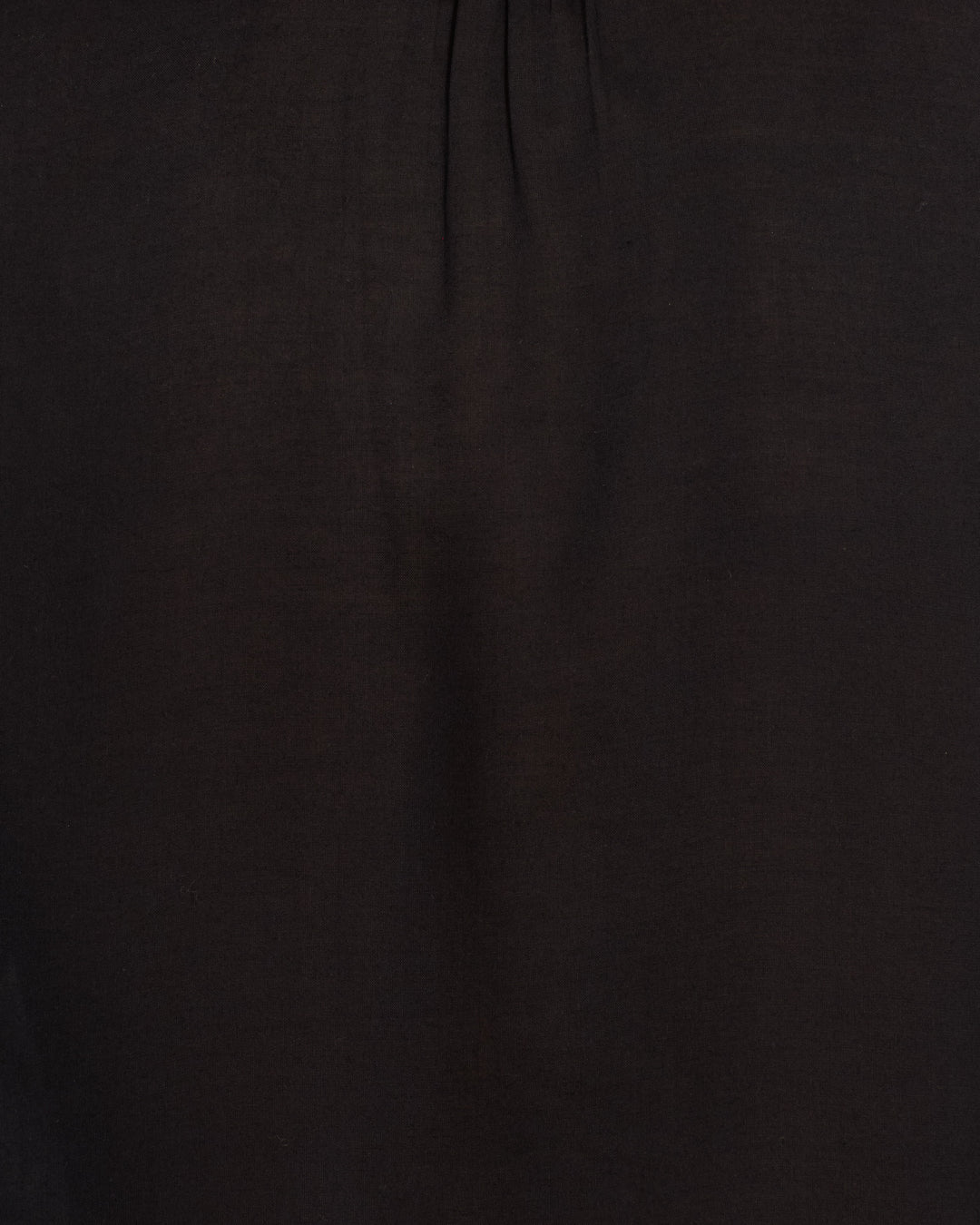 Close-up view of the Annabel Raven Wing Shirt in dark brown or black Tencel, highlighting a subtle vertical crease and a small gathered seam near the top for vintage-inspired style.