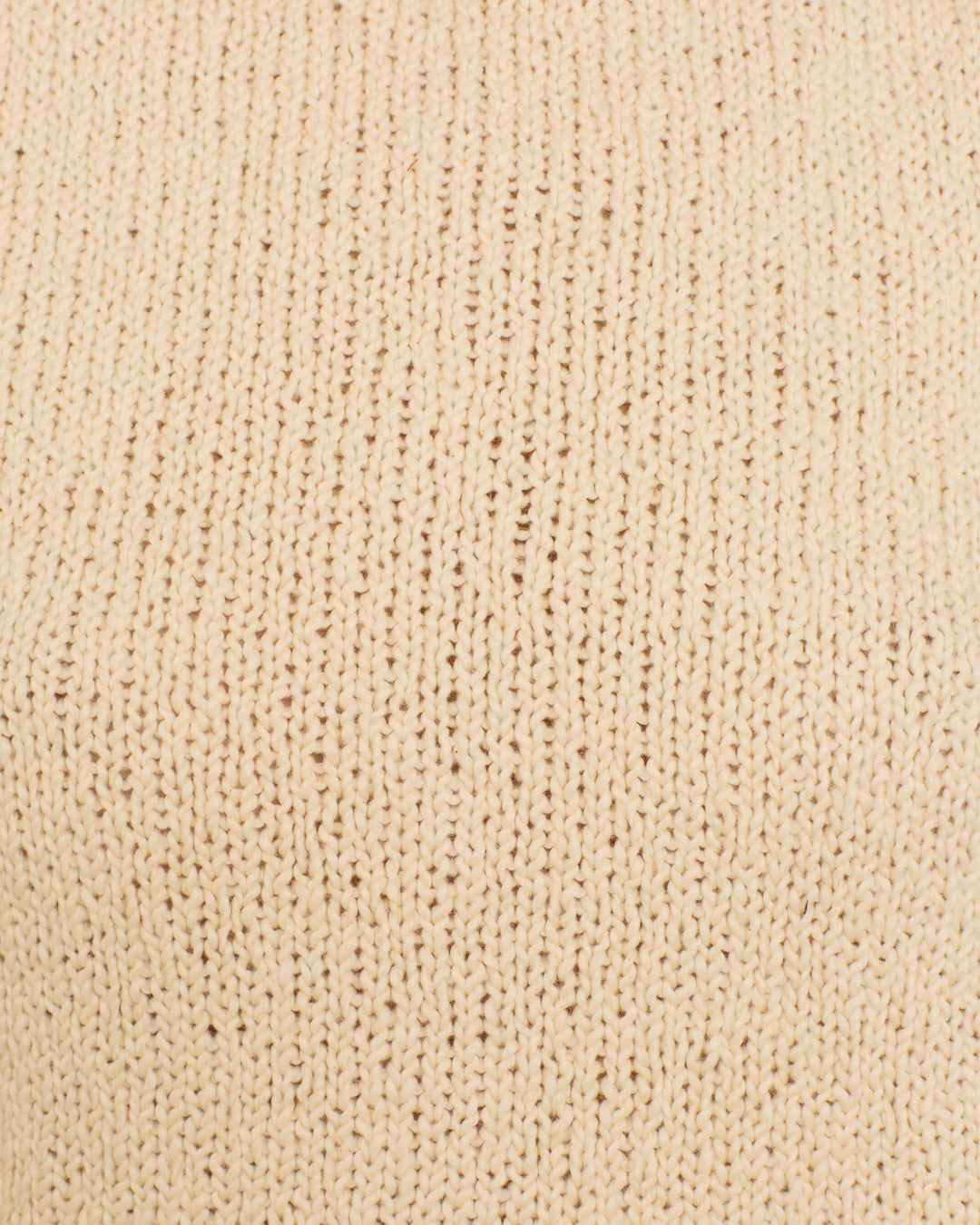 Close-up view of the Sonia Snow Fringe Top, featuring beige, artisan-made organic cotton fabric with a visible vertical stitch pattern.