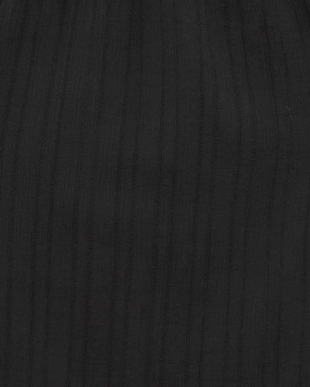 Close-up of the black ribbed fabric on the Winifred Shadow Lace Dress, featuring vertical textured stripes—perfect for a chic maxi dress look at holiday parties.