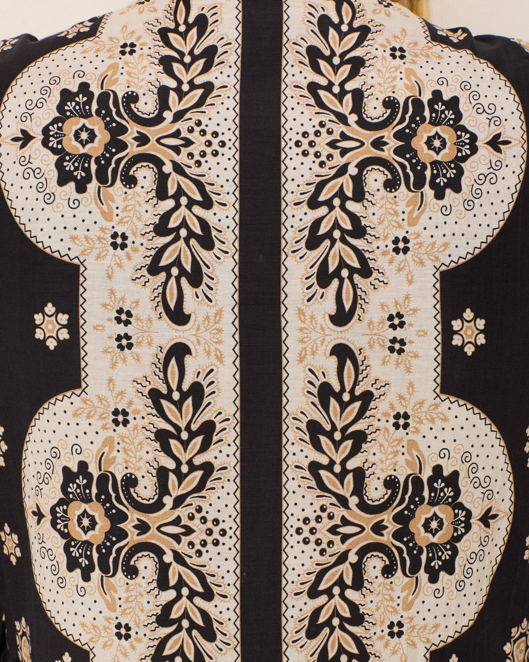 Close-up of fabric from the Winifred Bronco Bandana Dress, featuring a symmetrical black and beige floral and leaf print on a light background—perfect for Western-inspired or bandana-style looks.