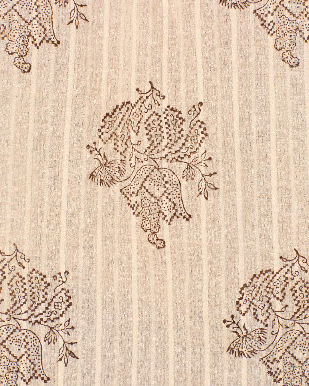 Crafted from cotton dobby fabric, the Artemis Grapevine Stripe Shirt showcases a beige backdrop with thin vertical stripes and a repeating brown floral and bird motif arranged in a symmetrical pattern. Hand block printed details enhance its classic appeal, lending an artisanal charm and delicate touch perfect for any occasion.