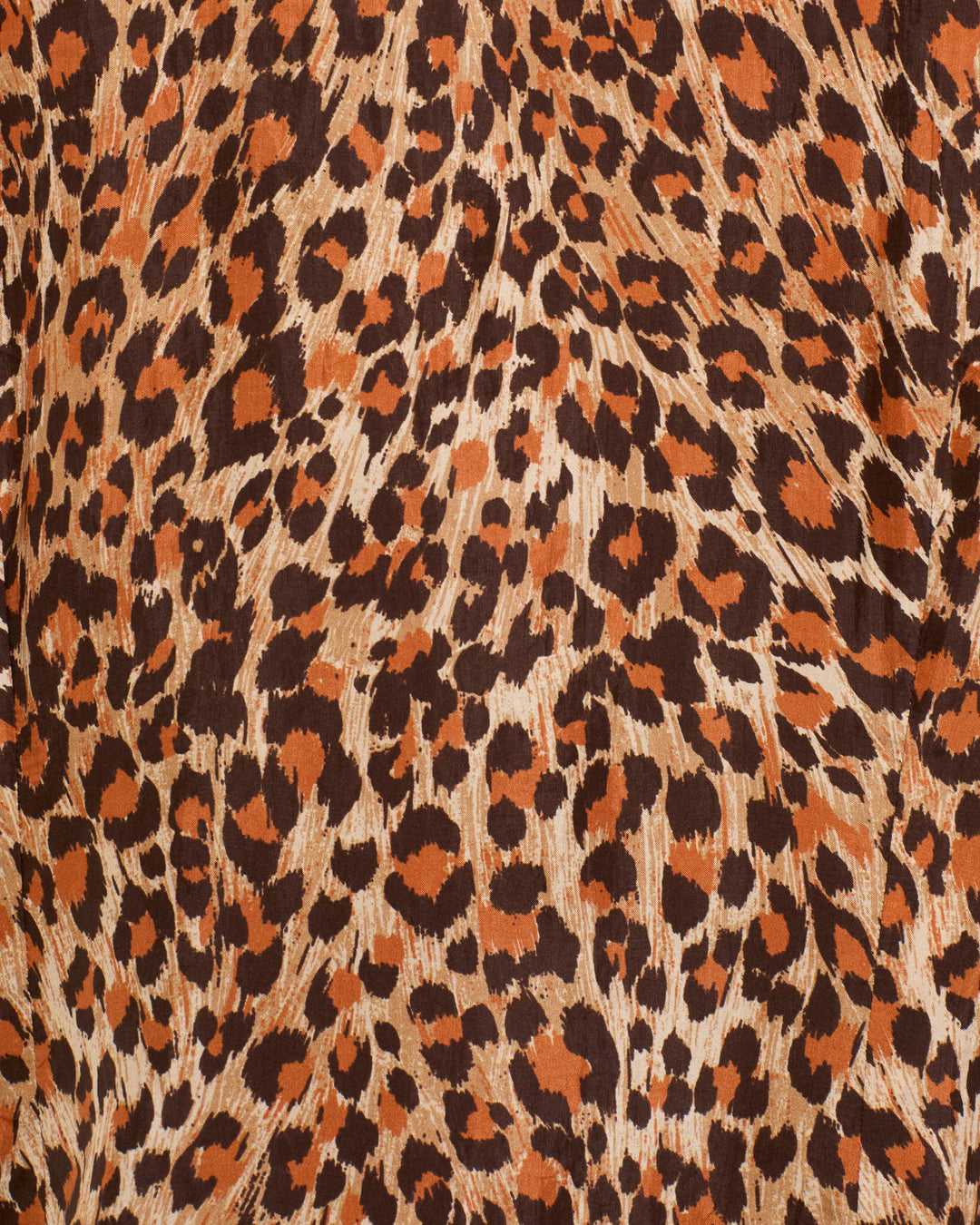 Close-up of a Dana Leopard Trek Silk Shirt featuring a hand-loomed brown and tan leopard print pattern.