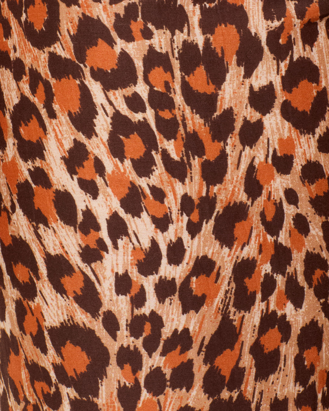 Close-up of the Farah Leopard Trek Pant fabric, showcasing a brown and orange leopard print with irregular dark spots and textured lines—perfect for crafting bold high-waisted pants or statement bell-bottom flares.