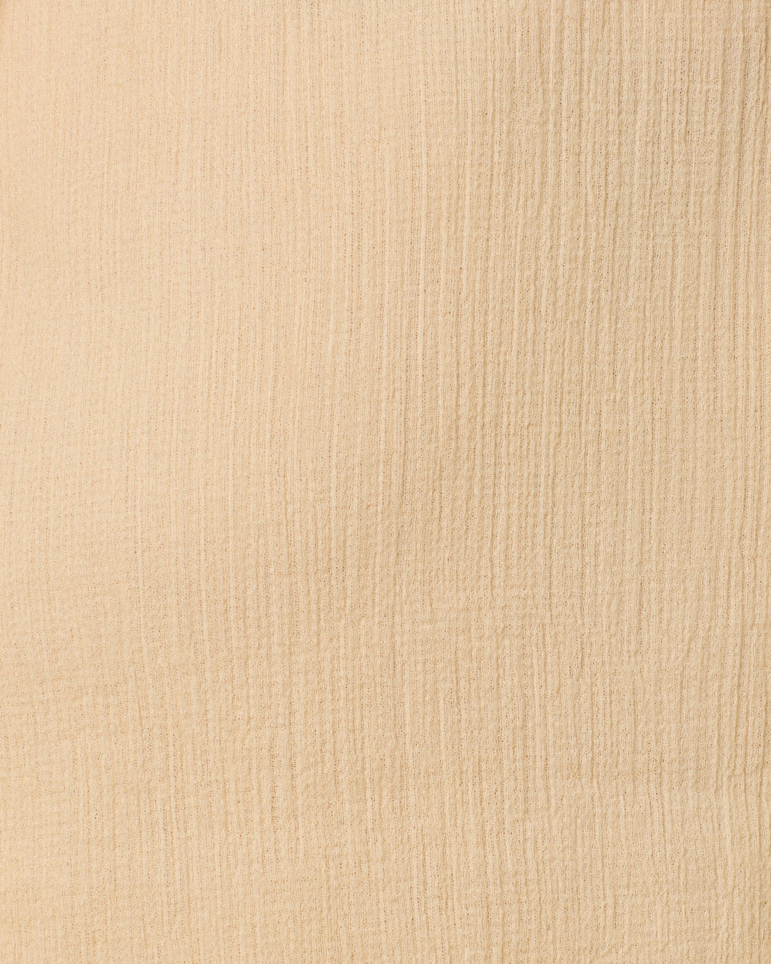 Close-up of a textured beige fabric surface with vertical and horizontal lines, reminiscent of the delicate weave found in the Parvati Prairie Tint Dress.